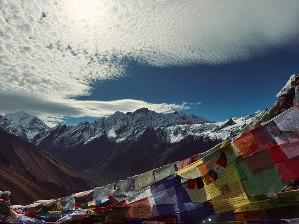 pexels-photo-31677808-31677808 Scenic view of snow-capped Himalayas with vibrant Tibetan prayer flags fluttering, creating a peaceful atmosphere.